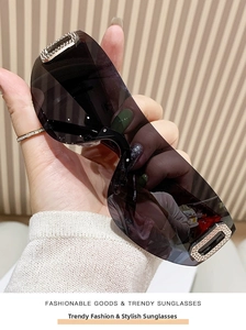 Detail of Y2K rimless sports sunglasses featuring grey lenses and silver rhinestone accents