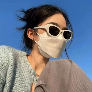 Retro white cat-eye sunglasses with dark lenses shown against a blue sky background