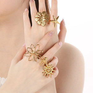 Five-piece gold adjustable ring set featuring starfish, leaf, and hollow flower motifs