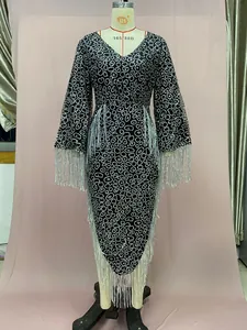 Close-up of shimmering silver fringe on V-neck long sleeve party dress with sequins