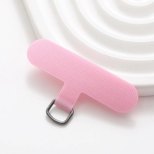 Close-up of pink nylon T-shape phone lanyard tether tab with grey metal D-ring attachment
