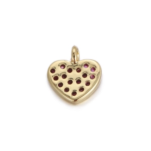 Close-up of a 14k gold-plated heart pendant with red crystal inlay for DIY jewelry