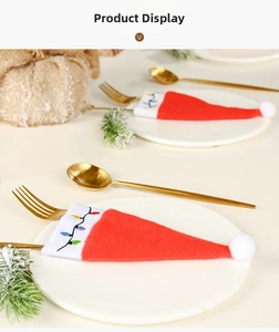 Close-up of festive red Christmas hat cutlery holder with colorful light embroidery
