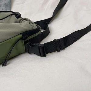 Mini crossbody phone bag in army green nylon with adjustable strap and buckle closure