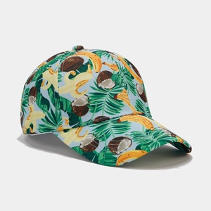 Close-up of tropical banana and palm leaf patterns on a blue canvas baseball cap