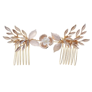 Luxurious gold floral hair comb with delicate leaves and pearls for bridal party hairstyles