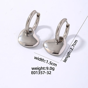 Macro shot of polished silver heart pendant earrings with size measurements details