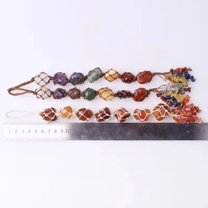 Detail view of handmade tree of life car charms showing 28cm length with a metal ruler