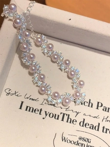 Macro shot of elegant purple pearls and pavé cubic zirconia on a luxury silver bracelet