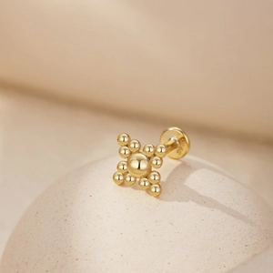 Macro view of gold S925 sterling silver heart crown earring detail with hallmark