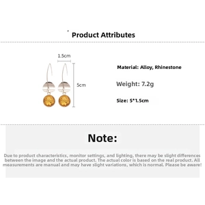 Detail shot of yellow rhinestone drop earrings showing 5cm height and 1.5cm width dimensions