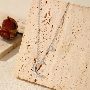 S925 sterling silver moon and star necklace with shimmering zircons on stone