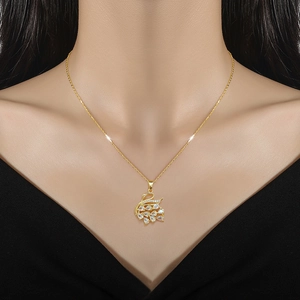 Close-up of sparkling full-crystal swan pendant on a gold-plated titanium steel necklace