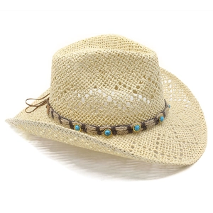 Detailed texture of hollow woven straw cowboy hat with turquoise ethnic beaded band