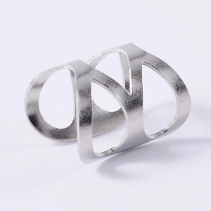 Macro view of minimalist hollow silver-colored cross ring with intricate line details
