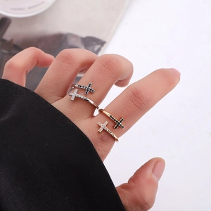 Minimalist silver and gold cross rings with zircon stones on model hand