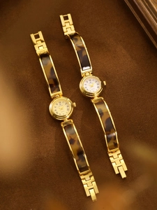 French style gold women's watch with amber tortoiseshell link strap and white dial