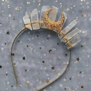 Detail of bohemian crown with raw white crystal pillars and golden crescent moon charm
