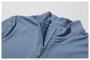 Detailed view of the light blue yoga jumpsuit featuring a half-zip neckline and smooth fabric