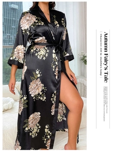 Detailed view of black satin bathrobe featuring elegant beige floral print and tie waist