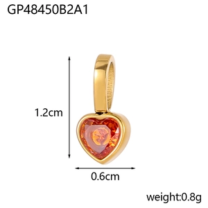 Macro detail of a 1.2cm gold-plated heart pendant with orange cubic zirconia stone