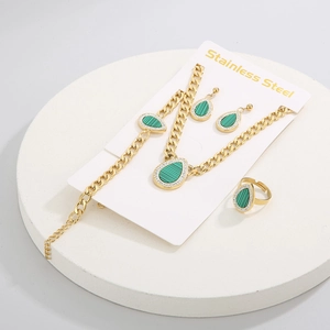 Detail of green teardrop pendant set in stainless steel with necklace and earrings