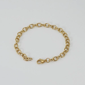 Polished 18K gold stainless steel chain bracelet with lobster clasp on a grey background