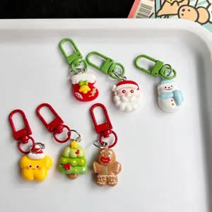 6-piece Christmas resin keychain set with Santa Claus and Snowman on white tray