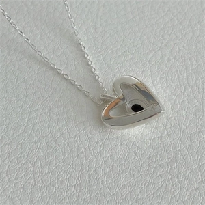 Detail shot of heart-shaped S925 sterling silver pendant with engraved hallmark