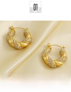 Detail of twisted 18k gold plated titanium steel hoop earrings with pavé rhinestones