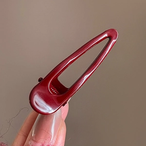 Minimalist geometric hollow hair clip in burgundy lacquer finish for hair styling