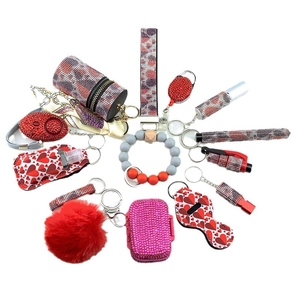 14-piece self-defense keychain set with leopard rhinestone alarm and plush ball