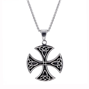 Macro shot of silver Viking Celtic cross pendant with intricate woven knot textures