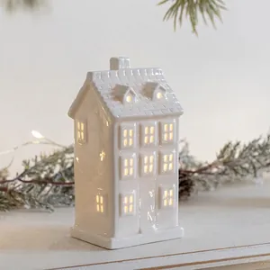 White ceramic house ornament with warm LED light for Christmas desktop decoration
