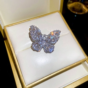 Close-up of luxury butterfly brooch with sparkling zircons and gold plating in gift box
