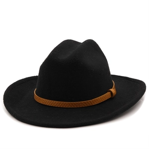 Close-up of black wool fedora with brown braided leather band detailing on white background