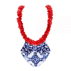 Detail of blue floral print one-piece swimsuit with red 3D flower halter neck strap