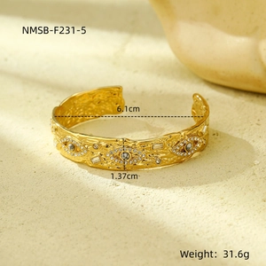Detailed view of vintage gold evil eye bangle with marble beads and size specifications