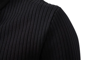 Macro shot of vertical ribbed knitting texture on a men's black knit shirt shoulder