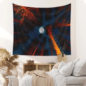 Bohemian forest tapestry with moon and stars hanging in a minimalist bedroom decor