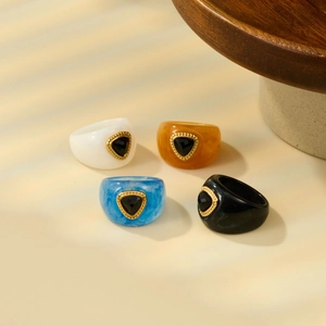 Square resin rings with gold trim and black triangular stones in white brown blue black