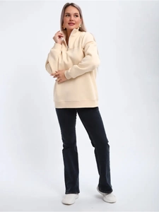 Detail of half-zip stand collar and ribbed cuffs on beige fleece pullover sweatshirt