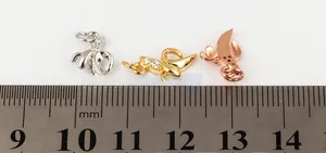 Three tiny banana pendants in gold, silver and rose gold with micro-inlaid zircons
