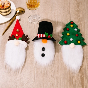 Three-piece Christmas wine bottle covers featuring Santa, snowman, and tree designs