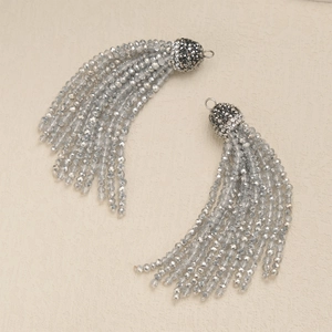 Macro shot of 2mm grey crystal bead tassel earrings with rhinestone caps and metal rings