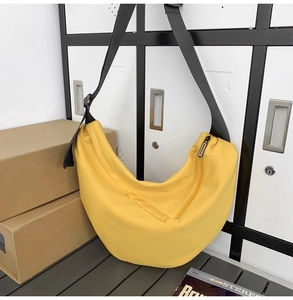 Detailed view of the yellow nylon crossbody bag with durable texture and quality stitching