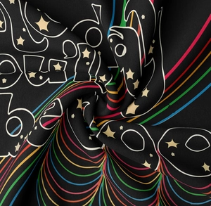 Detail shot of black bohemian tapestry fabric with colorful rainbow and white graphic patterns