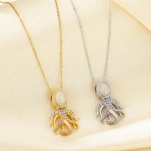 Elegant gold and silver octopus necklaces with pearls and crystals on champagne satin