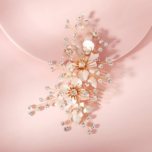 Detail of bridal hair comb with gold alloy flowers, pearls, and sparkling crystals