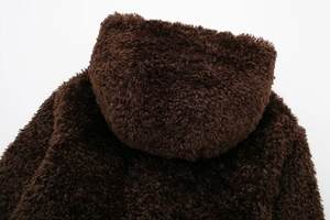 Close-up view of the dark brown faux fur texture on the hood and shoulder of the coat